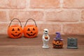 Halloween pumpkin Jack O' lantern, grave, and mummy on wood. Royalty Free Stock Photo