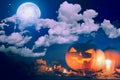 Halloween pumpkin Jack-o'-lantern on wooden table with candles in a spooky night over moon and clouds Royalty Free Stock Photo