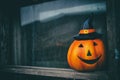 Halloween pumpkin look out dark window. Halloween party decoration Royalty Free Stock Photo