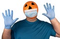 Halloween pumpkin in a medical respiratory bandage face. Surgical protective mask. person with orange evil mask Royalty Free Stock Photo