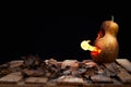 Halloween pumpkin minion spewing flames of fire on a black background