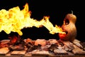 Halloween pumpkin minion spewing flames of fire on a black background