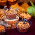 Halloween Pumpkin Muffins Decorated with Spiders and Spider Web Royalty Free Stock Photo