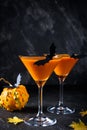 Halloween pumpkin orange cocktails. Festive drink. Halloween party. Funny Pumpkin with holiday decorations