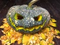 Halloween is the pumpkin. Halloween pumpkins decorated with pumpkin seeds placed on a wooden table.