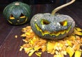 Halloween is the pumpkin. Halloween pumpkins decorated with pumpkin seeds placed on a wooden table.