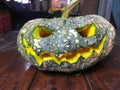 Halloween is the pumpkin. Halloween pumpkins decorated with pumpkin seeds placed on a wooden table.