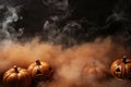 Halloween pumpkin with a scary luminous face design with copy space on a fog smoke dark background Royalty Free Stock Photo