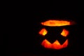 Halloween pumpkin smile and scary eyes for a party, Jack Lantern isolated on black background Royalty Free Stock Photo