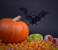 Halloween pumpkin with spooky bat, eyes and candy corn candies stock images Royalty Free Stock Photo