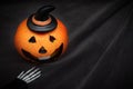 Halloween pumpkin with spooky smiling face on dark black background wiyh copy space