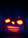 A halloween pumpkin wearing an anti covid surgical mask