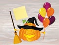 Halloween. Pumpkin in a witch hat with a broom and a lot of ball