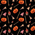 Halloween pumpkins, bag of herbs, cakes with finger and brooms on black background. pumpkin with scary smile