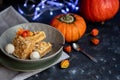 Halloween Pumpkins of bright orange color lie on a dark background, next to red berries. Royalty Free Stock Photo