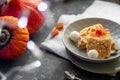 Halloween Pumpkins of bright orange color lie on a dark background, next to red berries. Royalty Free Stock Photo