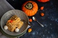 Halloween Pumpkins of bright orange color lie on a dark background, next to red berries. Royalty Free Stock Photo