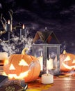 Halloween pumpkins burning in front of a graveyard