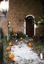 Halloween pumpkins and decorations outside a house