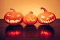 Halloween pumpkins family portrait with shining smile in vibrant orange colors