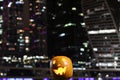 Halloween Pumpkins head. Orange pumpkin with a smile and eyes on night city and lights background Royalty Free Stock Photo