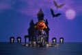 Halloween pumpkins jack-o-lantern on dark purple background. Royalty Free Stock Photo