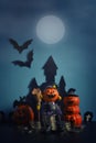 Halloween pumpkins jack-o-lantern with money coin stack growing business on dark blue background. Royalty Free Stock Photo