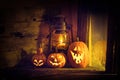 Halloween pumpkins and lantern in an old house by the window where the moonlight shines Royalty Free Stock Photo