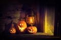 Halloween pumpkins and lantern in an old house by the window where the moonlight shines Royalty Free Stock Photo