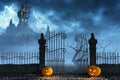 Halloween pumpkins next to a gate of a spooky castle