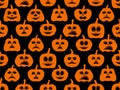 Halloween pumpkins with scary faces on a black background. Evil pumpkins seamless pattern. Jack-o lantern for wrapping paper,