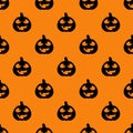 Halloween pumpkins seamless pattern. Black silhouette halloween pumpkin on orange background. Halloween background with carving