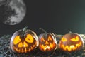 Halloween pumpkins at wood background. Carved scary faces of pumpkin.