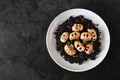 Halloween risotto with skull mushrooms and black rice over a black background Royalty Free Stock Photo