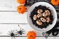 Halloween risotto with skull mushrooms and black rice, table scene over white wood Royalty Free Stock Photo