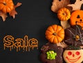 Funny halloween gingerbread cookies on black wooden table. Halloween sale