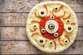 Halloween scary food funny eye monster pizza horror with mozzarella and tomato