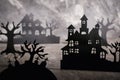 Halloween scene. Paper houses and dark misty trees in graveyard