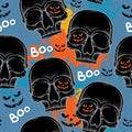 Halloween seamless pattern with dotted skulls in black and colorful blots Royalty Free Stock Photo