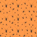 Halloween seamless pattern made with creepy black beetles with long whiskers on orange background, as a backdrop or texture.