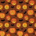 Halloween seamless pattern with orange pumpkins carved faces and black bats on brown background Royalty Free Stock Photo