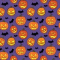 Halloween seamless pattern with orange pumpkins carved faces and black bats on ultraviolet background Royalty Free Stock Photo