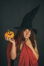 Halloween senior lady holding pumpkin on black background