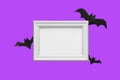 Halloween set decorations with bat and mock up empty frame on violet very peri background. Holiday party composition