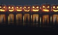 Halloween Set of pumpkin for holiday. Row of Jack O'Lanterns with red candles on reflection floor. 3d rendering. Royalty Free Stock Photo