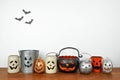 Halloween shelf display with rustic jack o lantern candle holder decor against a white wall Royalty Free Stock Photo