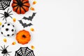 Halloween side border flat lay of pumpkins, candy and decor, over a white background Royalty Free Stock Photo