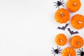 Halloween side border of orange pumpkins with black bats and spiders over a white background Royalty Free Stock Photo