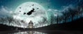 Halloween Silhouette of Witch flying over the full moon Royalty Free Stock Photo