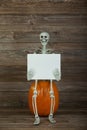 Halloween skeleton holding blank sign Royalty Free Stock Photo